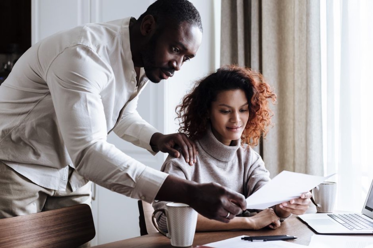 Network vs traditional plans explained Couple reviewing documents at home