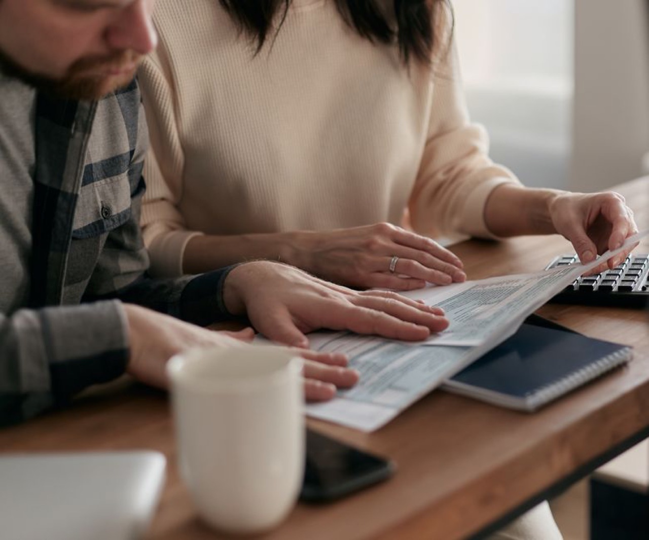 Waiting periods, PMBs and penalties Couple reviewing documents at home