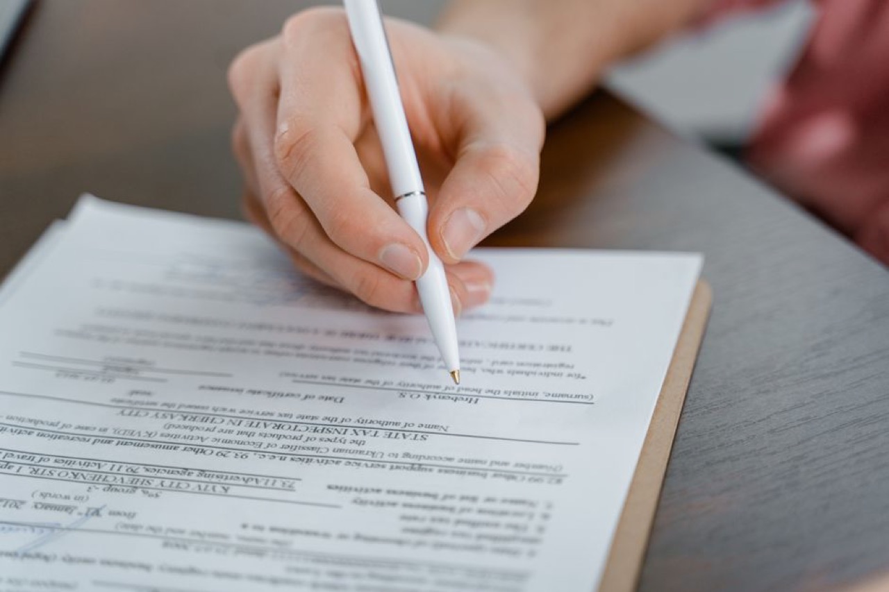 Questions to ask before joining a medical aid scheme Filling in a form with pen